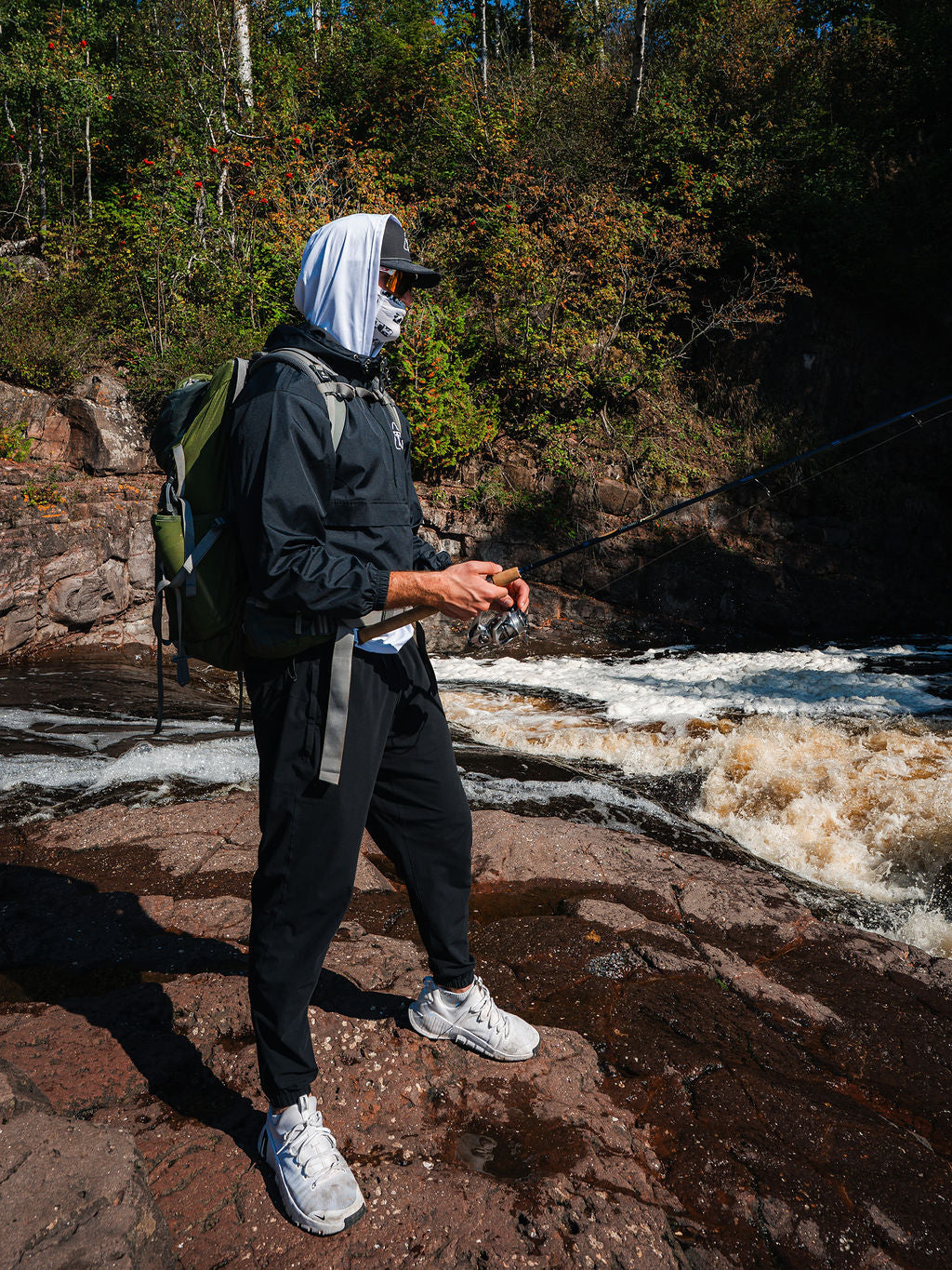 A man fishing wearing all Zero Trace Baits merchandise