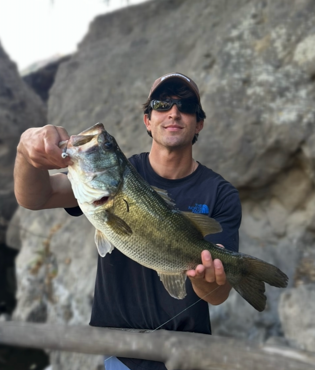 Man holding a large bass caught on a biodegradable Zero Trace Baits Deadly Ned