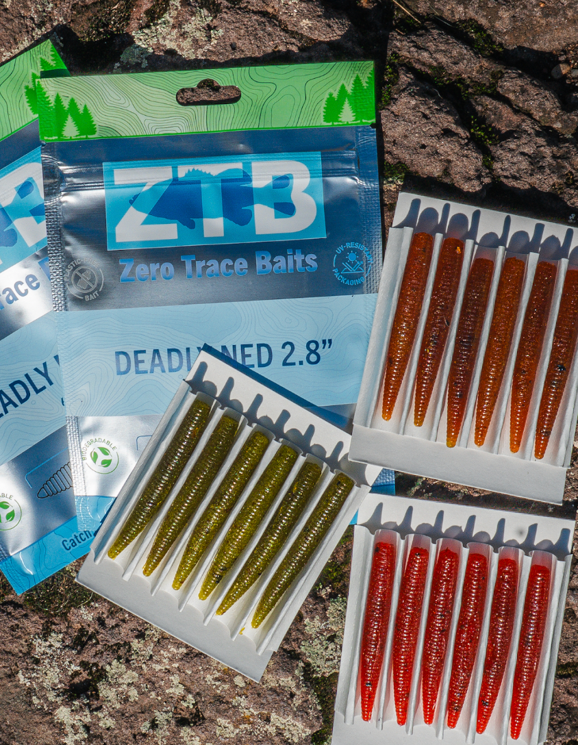 Zero Trace Baits packages with deadbaits on a rocky surface
